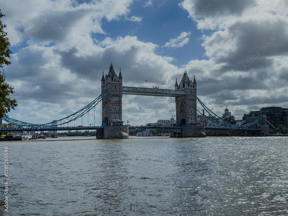 Obraz premium Stunning aerial view of Tower Bridge in London, spanning the River Thames with the city skyline in the background — blending historic architecture and modern urban beauty. London Bridge