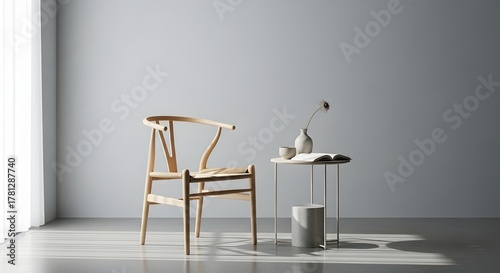 Minimalist interior with a light wood wishbone chair and small side table