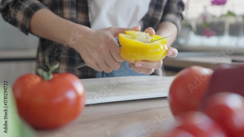 Cleaning Yellow Bell Pepper For Fresh Salad Preparation In Modern Kitchen