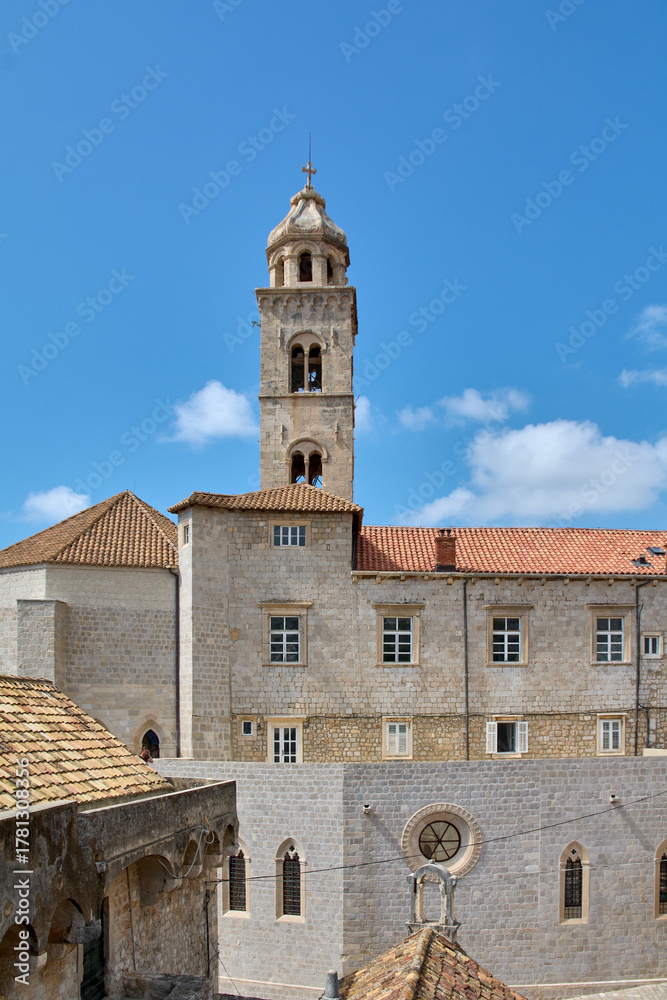 Obraz premium The Franciscan Monastery bell tower and rooftops in Dubrovnik