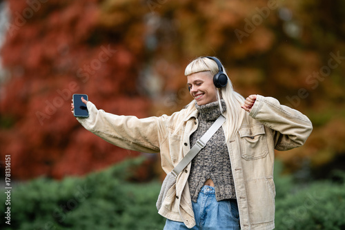 Woman enjoying music and dancing in park