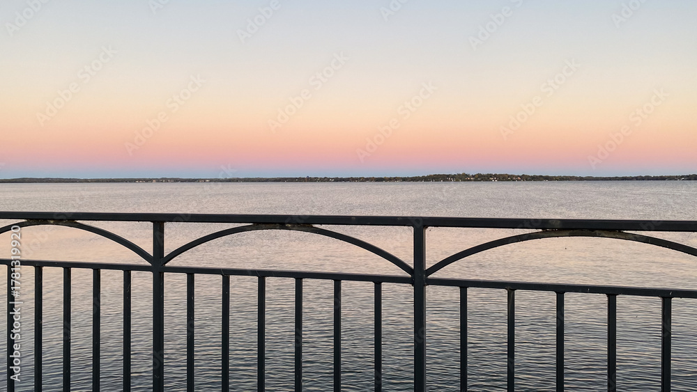 Fototapeta premium Guard Rail Over Lake Monona at Sunset