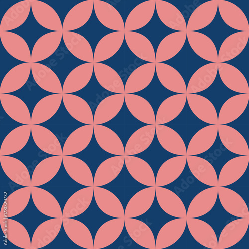 Seamless geometric pattern with interlocking pink petal shapes on a deep navy background, creating an elegant, modern, and harmonious design.