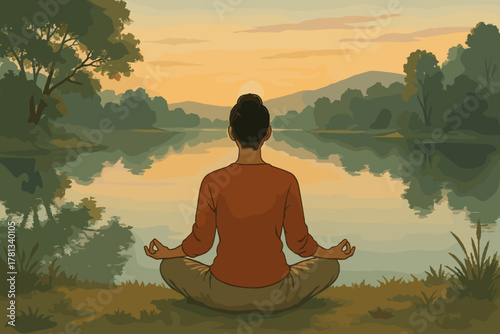 Woman meditating in a serene natural setting at sunset, seated on the grass by a calm lake, surrounded by trees and hills.