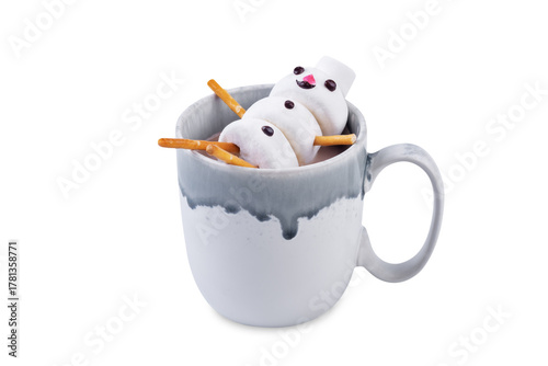 Hot cocoa drink wth marshmallows in the form of snowman in a cup for Christmas holidays on a white isolated background