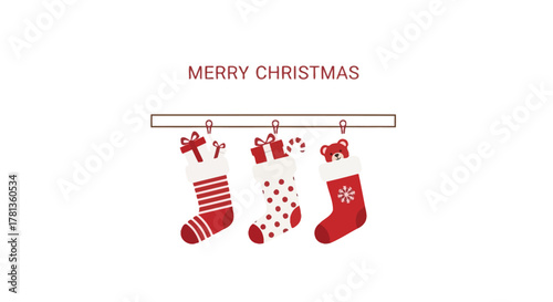Three festive christmas stockings filled with gifts and candy hanging on a wooden mantelpiece with merry christmas text
