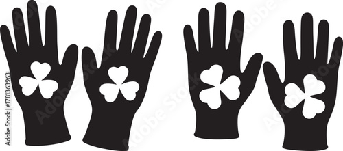 Four black silhouette gloves with white shamrock designs silhouette