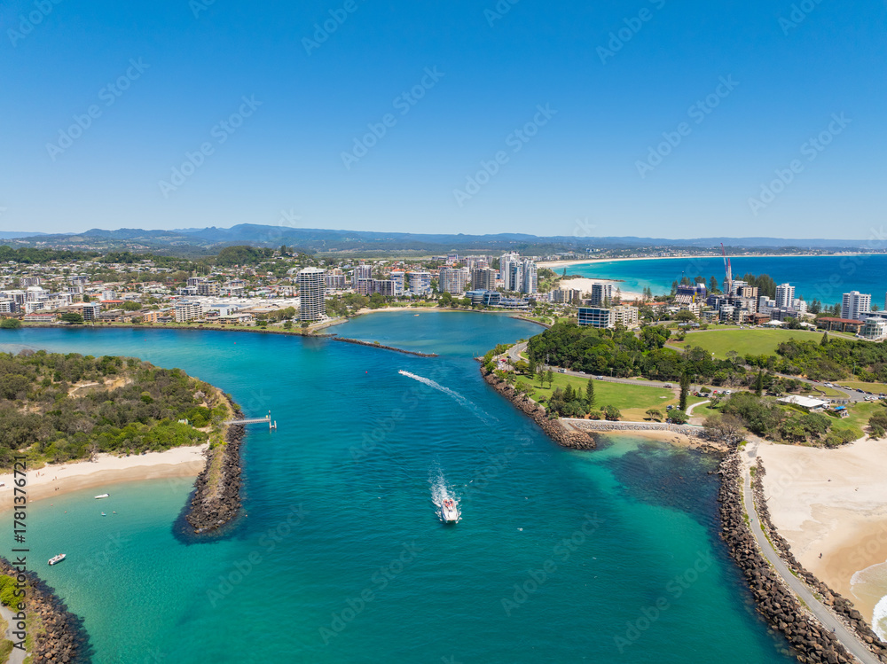 Fototapeta premium Aerial views of the Tweed Heads coast with Fingal Head to the south and Duranbah beach to the north, the Tweed river inlet in the foreground and Tweed Heads and Coolangatta skyline in the background