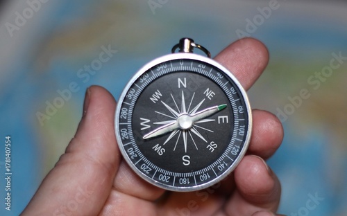 compass in hand and the map atlas 