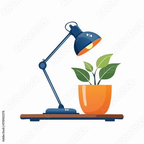 Desk lamp illuminating a potted plant on a wooden surface, creating a warm ambiance