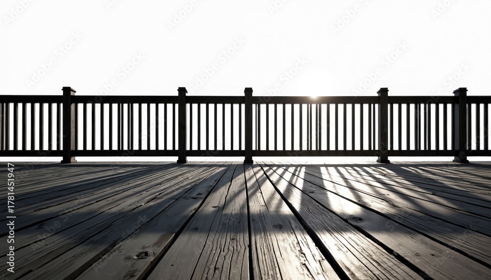 Obraz premium Wooden deck and railing over white background. Sunlight shines through the wooden planks creating a pattern of light and shadow. Balcony with wooden floor surface. Wood pattern on deck space.