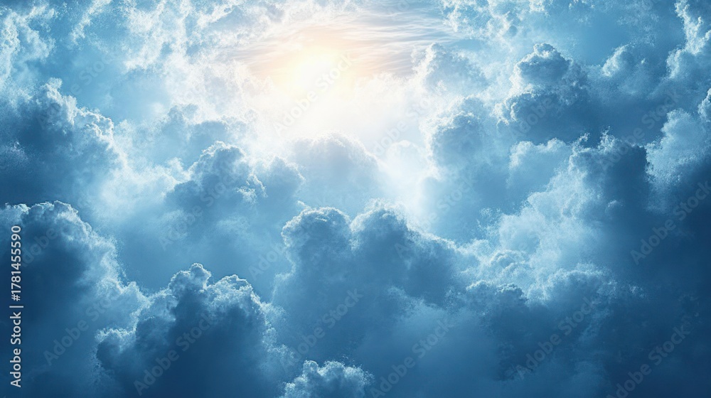 Fototapeta premium Bright sun shining through thick, fluffy clouds in a vibrant blue sky creating a serene and uplifting atmosphere