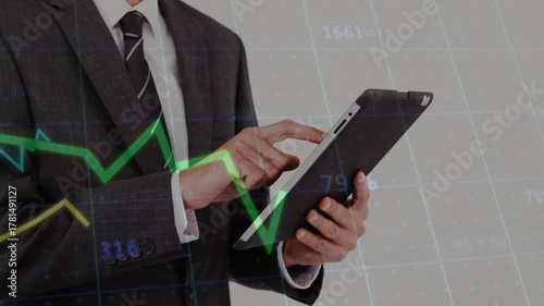 Analyst initiating tablet tap, following green spike while tapping, swiping, tracking market charts