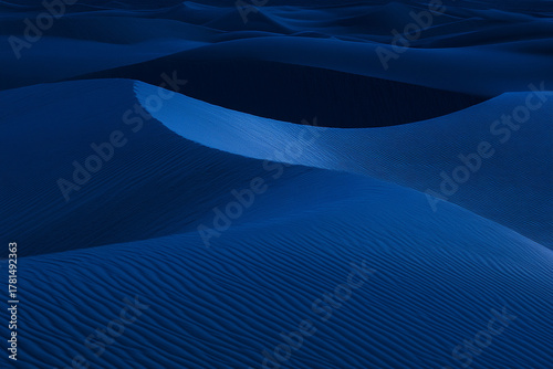 Fototapeta Naklejka Na Ścianę i Meble -  blue-hour desert scene, where subtle light reveals intricate dune patterns