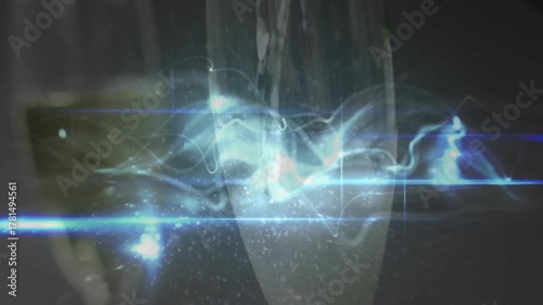 Green bottle entering and pouring into flute, creating sparkling liquid and light ribbon refraction