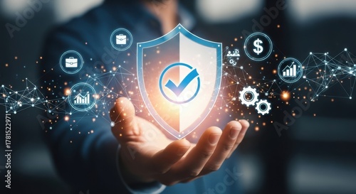 Financial Security Protection: Hand Holding Glowing Shield Icon with Checkmark Surrounded by Business and Money Icons for Corporate Safety and Investment Assurance