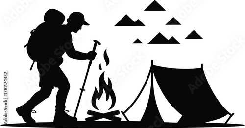 Hiker enjoying campfire with tent and mountains in silhouette