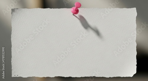Blank white card pinned to wall casting shadow, perfect for message, reminder or creative concept, conveying simplicity and minimalism.
