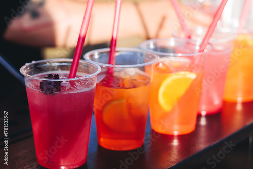 Photography Barman mixing liquor beverages and alcohol drinks in plastic cups, bartender wor