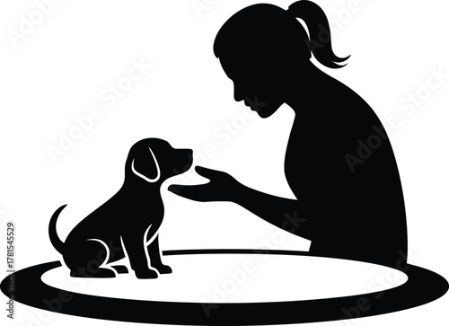 Woman affectionately petting a cute puppy in a charming silhouette