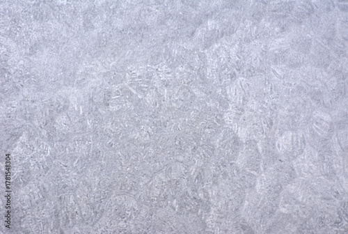 A close-up of a roughly finished gray marble surface with characteristic processing marks.