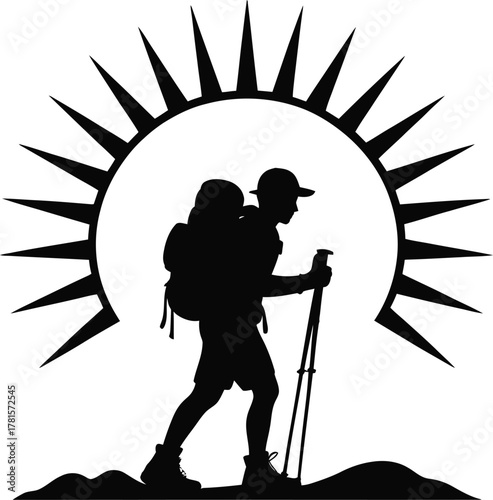 Silhouette of a hiker with trekking poles against a vibrant sun