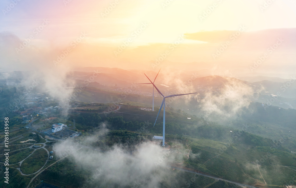 Fototapeta premium Majestic wind generator amidst misty landscape in Da lat Vietnam at sunrise