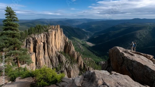 Adventurous climber reaches summit rocky mountain range photography majestic nature wide-angle view exploration