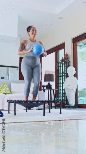 Fit woman jumping on a trampoline during a home workout