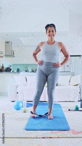 Mature woman exercising with a resistance band at home