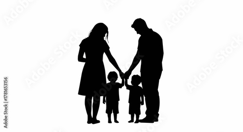 Silhouette of a family with two young children holding hands.