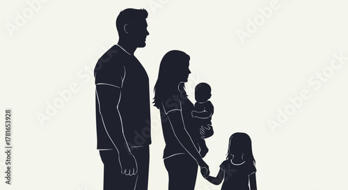 Silhouette of a young family with two children standing together.