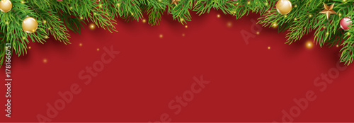 Christmas red background with pine branches and ornaments for card or banner.