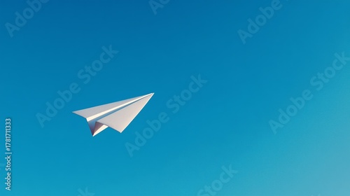 Paper airplane soaring overhead in a clear blue sky, symbolizing travel and new ideas with copy space
