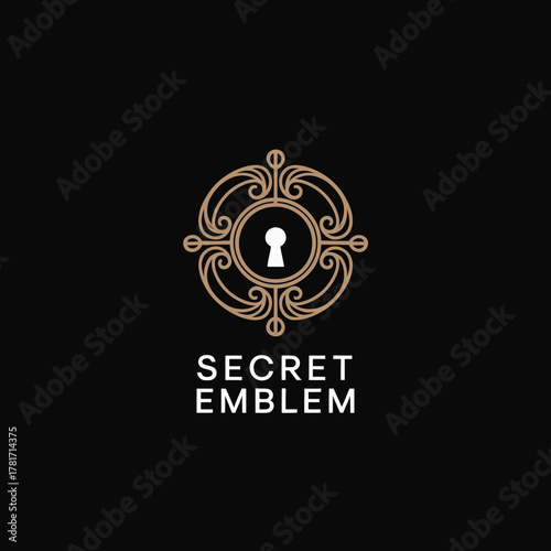 This elegant black emblem features a central keyhole design embedded within ornate detailing, representing sophistication and mystery, perfect for luxury branding.