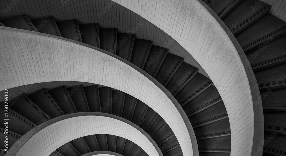 Fototapeta premium Abstract monochrome spiral staircase architecture with repeating patterns and geometric forms viewed from above