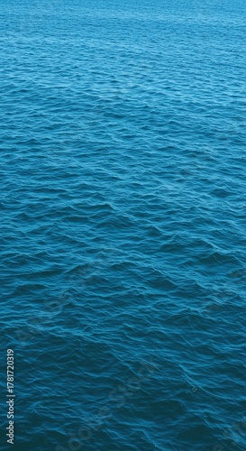 Expansive azure ocean salt water shimmering under natural light, showcasing its deep blue hues and the gentle movement of its vast, pure liquid ,element ,aquatic ,deep blue