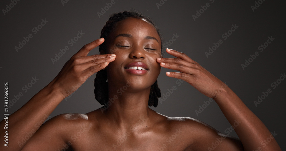 Fototapeta premium Skincare, natural beauty and black woman with hands in studio for hydration, wellness and cosmetics. Space, dermatology and person with touch, smile and aesthetic for healthy skin on dark background