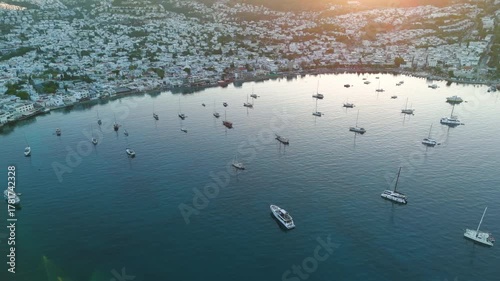 Bodrum, Turkey. Aerial drone shot of bay with stationary yachts, beachfront promenade and seaside houses in cool morning light.. Aerial View
