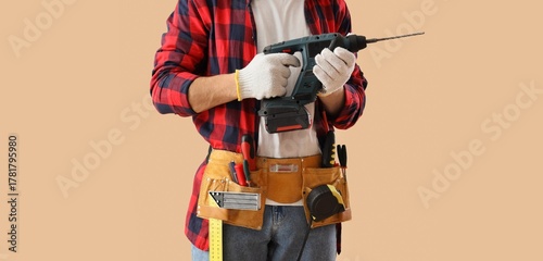Male worker with drill and ...