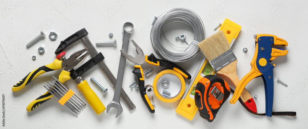 Obraz premium Wires and construction tools on white grunge background