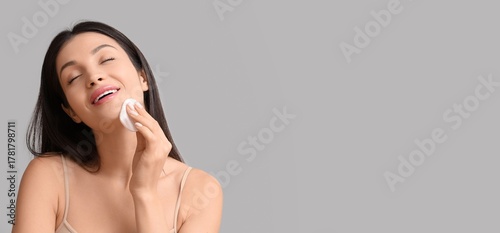 Beautiful young woman wipin...