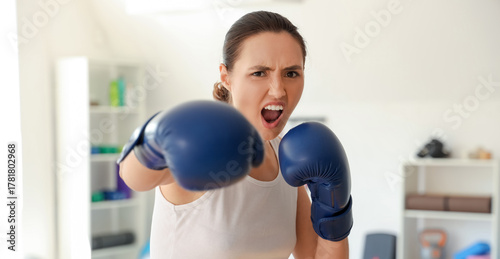 Young woman in boxing glove...