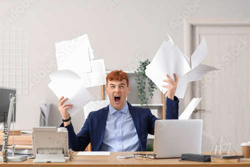 Angry redhead businessman t...