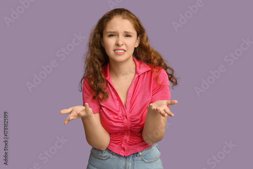 Portrait of confused young ...