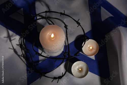 Burning candles with barbed...