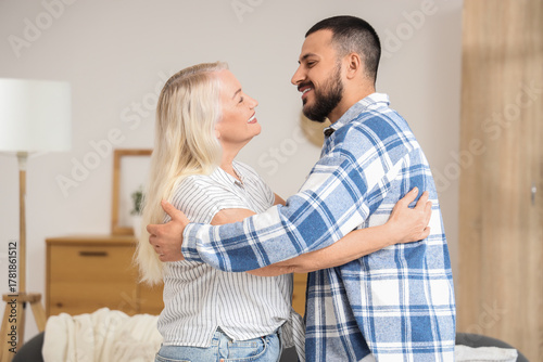 Happy young man hugging his...