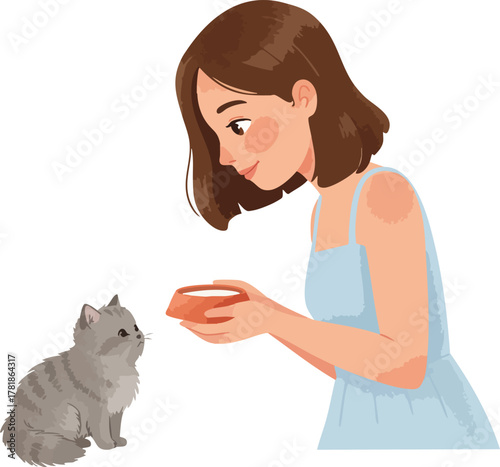 A woman offers food to a gray cat from a bowl in her hand.