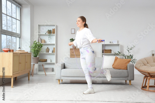 Sporty young woman jumping ...