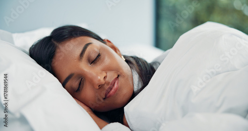 Blanket, relax and sleeping with woman in bed of hotel for comfort, peaceful nap or resting. Asleep, break and tired with Indian person in bedroom for accommodation, hospitality or lazy weekend